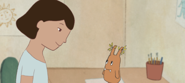 an animated drawing of a girl looking at a little fictional creature on her desk