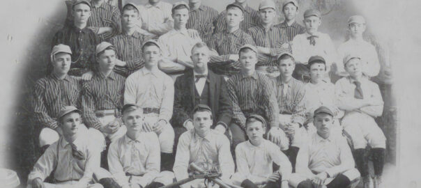 A baseball team appears in a historical black and white photo